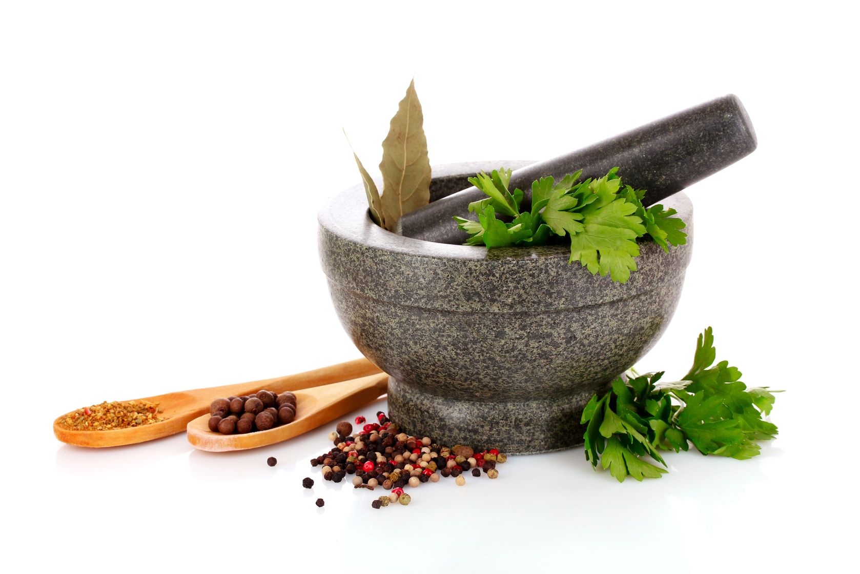 9621231 - mortar and pestle, parsley, bay leaf and pepper isolated on white